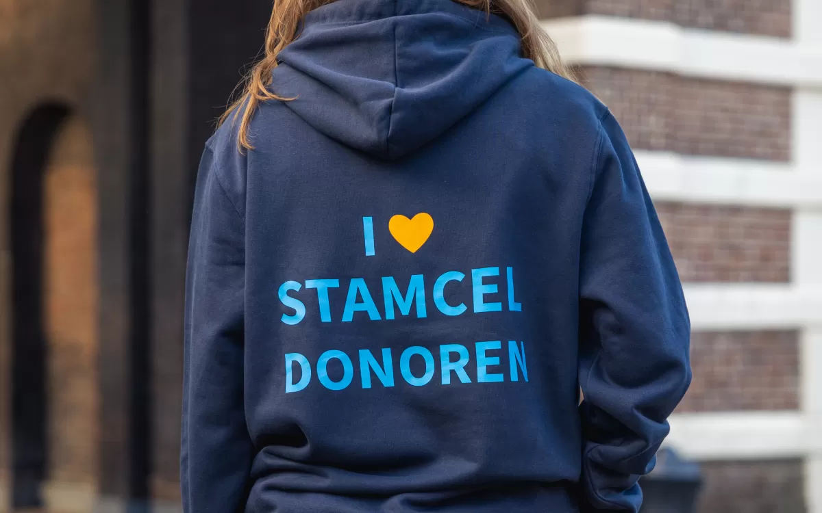 Maxime met haar rug naar ons toe in donkerblauwe Matchis trui